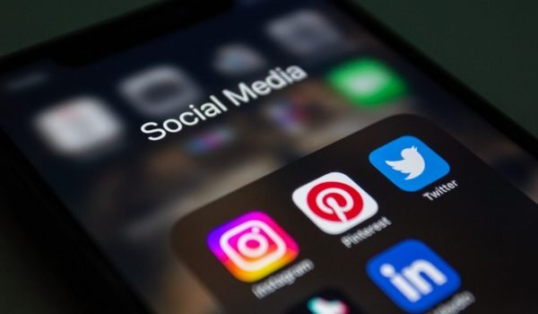 a close up of a cell phone with social media icons on it